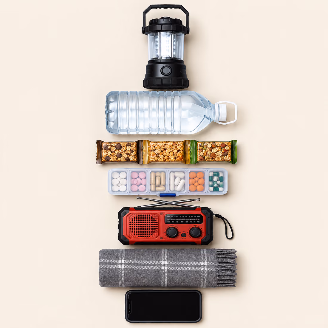 Illustration of the seven-layer emergency kit: lantern, water, food, medications, radio, blanket and phone